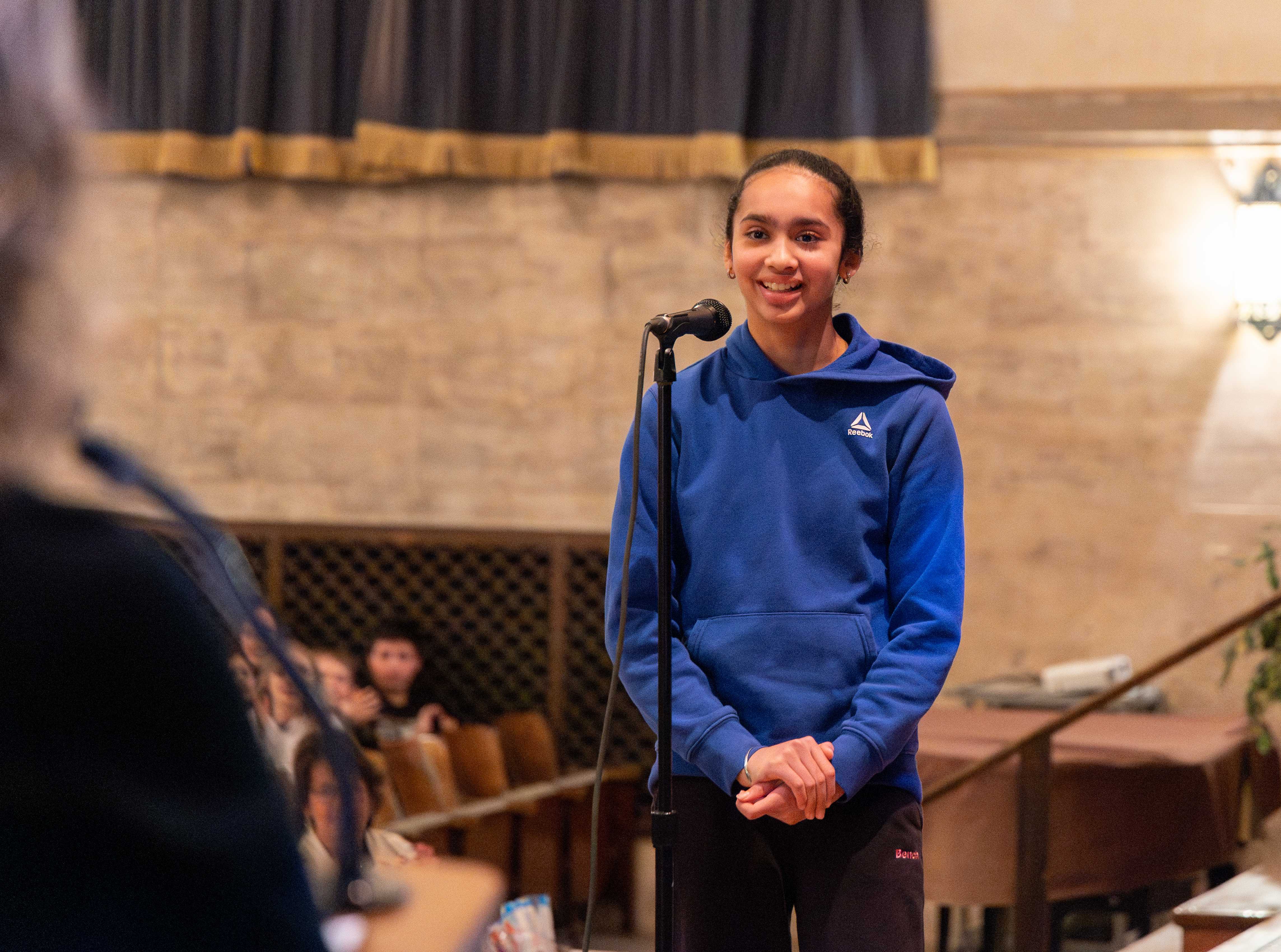 Our first 1st place winner smiles as she spells her last word correctly